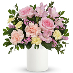 Fresh as a spring breeze, this whimsical, blush-hued arrangement presented in a simple white pot, is the perfect Mother's Day gi