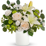 This ethereal arrangement is a calming, peaceful gesture that shows them you care. Elegant white blooms accompany a timeless whi