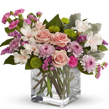 Clear glass cube arrangement of mid pink roses, soft pink alstroemeria, lavender mini carnations & cushion spray chrysanthemums,