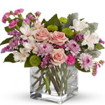 Clear glass cube arrangement of mid pink roses, soft pink alstroemeria, lavender mini carnations & cushion spray chrysanthemums,
