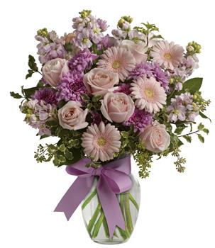 Simply divine! Send them a slice of heaven with this lavish presentation of roses, gerberas and stock in a vase.