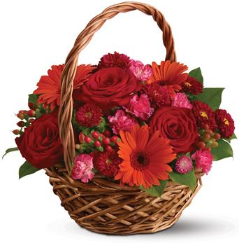 Rich red roses, pretty pink carnations and sunny orange gerberas make this basket a glorious, go-anywhere garden