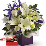 Gorgeous white lilies and delicate blue iris dance gracefully with roses and alstroemeria in this luxurious arrangement.