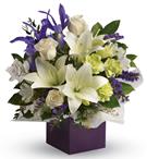 Gorgeous white lilies and delicate blue iris dance gracefully with roses and alstroemeria in this luxurious arrangement.