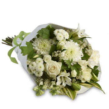 Simply stylish bouquet of all whites accented with seasonal greens