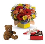 You will want to put this colourful arrangement with chocolates and teddy.