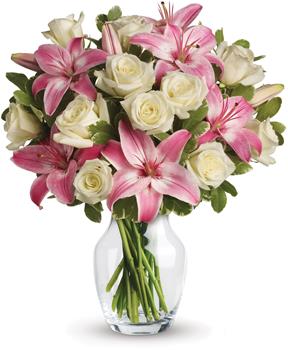 - A romantic gift like this one is always appreciated. An eyecatching display of roses and lilies is perfectly arranged in a cle