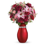 Surprise your Valentine with luscious red roses and pink lilies presented in the XOXO keepsake vase. Youll get a very warm rece