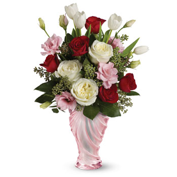 Tickle her heart with this flirtatious mix of romantic roses, lisianthus and tulips. This bouquet is arranged in our elegant Lov