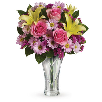 Ring in spring with roses and lilies arranged in a simple Heartfelt keepsake vase. A wonderful way to brighten up the season!
