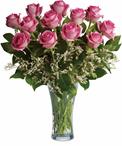 Make a statement! This lush arrangement of hot pink roses and greenery can be a fabulously romantic gift.