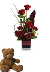 Roses, the traditional flower of love, receive a modern twist in this imaginative arrangement and a teddy.