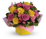 This stunning arrangement of pink and yellow roses adds an instant smile to anyone's face.