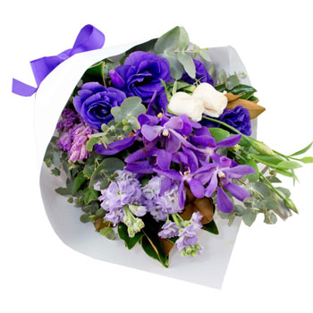 Perfect purple bouquet to include purple stock, purple lisianthus, cream roses, singapore orchids,purple hyacinth with greenery.