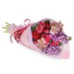 Someone you know will jump for joy when they receive this charming bouquet. Soft feminine colours wrapped in a pretty package