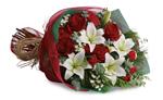 - Take your gift-giving to new heights with this dramatic arrangement! Classic red roses, snowy lilies and naturally festive ber