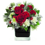 Christmas glam! Accents of silver captivate beneath this lush Christmas arrangement of rich red roses nestled amongst snow