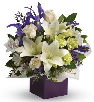 Gorgeous white lilies and delicate blue iris dance gracefully with roses and alstroemeria in this luxurious arrangement