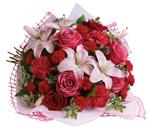 Give a bouquet that will completely capture her heart. A classic gift of roses and lilies that will truly delight!