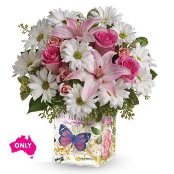 A charmingly feminine gift arranged in an Enchanted glass cube