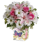 A charmingly feminine gift arranged in an Enchanted glass cube