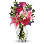 Brighten Mum's day with this gorgeous vase arrangement of hot pink roses, pink Stargazer lilies, accented with greens. It's a de